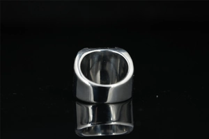 Detailed view of heavy polished stainless steel ring with a wide rectangular cross-section