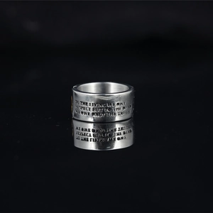 Two-tone skull engraved titanium steel ring with motivational quote on black background