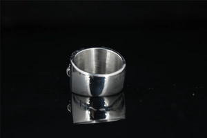 Detailed view of punk skull relief on polished stainless steel gothic ring with brushed inner