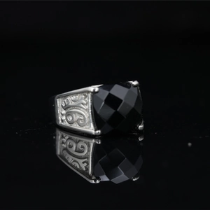 Vintage stainless steel ring for men featuring a large black gemstone and embossed details
