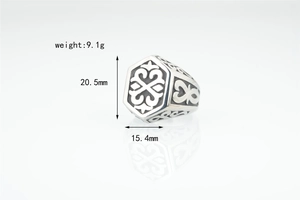 Close-up of hexagonal vintage signet ring in antique silver with geometric patterns