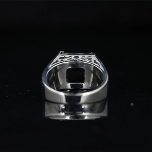 Vintage stainless steel ring for men featuring a black gemstone and hollow side patterns