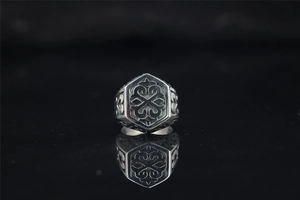 Macro detail of silver gothic ring with hexagonal pattern and vintage relief engraving