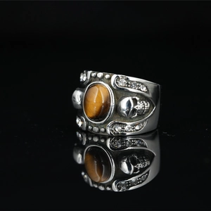 Gothic punk titanium steel ring with round tiger eye stone and skull relief design