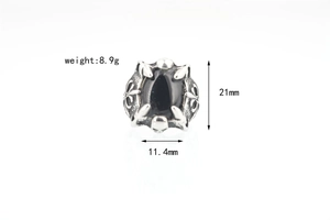 Macro view of gothic dragon claw ring with black drop stone and punk metal details