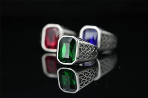 Macro detail of vintage silver-tone ring featuring a large rectangular green gemstone