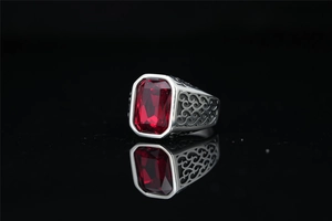 Macro detail of silver titanium ring featuring a large rectangular red gemstone setting