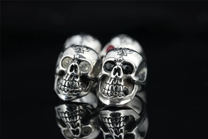Macro shot of vintage skull ring with cross engraving and black and white zircon stones