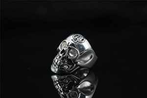 Detail of vintage skull ring with embedded crystals and number thirteen engraving