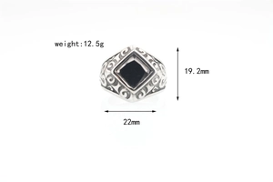 Detailed view of vintage titanium steel signet ring with black onyx stone and engraved sides