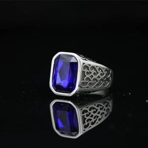 Vintage stainless steel ring with emerald-cut blue sapphire gemstone and ornate filigree