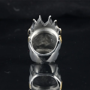 Retro punk titanium steel flame crown ring with gold accents on a reflective black surface