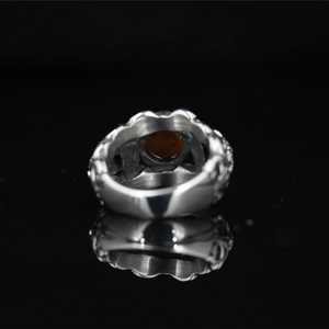 Vintage silver skull ring for men with carved textures and dark red round gemstone