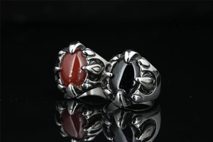 Macro view of gothic dragon claw rings featuring red and black agate stones