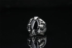Macro shot of punk style claw ring with oval black onyx stone in stainless steel