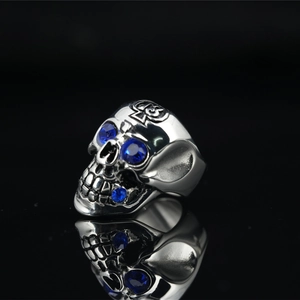 Gothic skull ring in silver titanium steel with blue rhinestones and cross texture