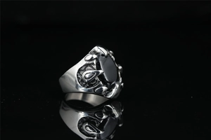 Macro shot of vintage gothic dragon claw ring featuring a large black onyx stone inlay