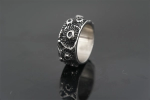 Macro detail of punk style titanium steel ring with vintage embossed crater texture