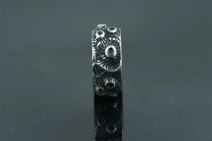 Macro shot of vintage silver titanium ring featuring rugged volcanic texture and oxidized finish