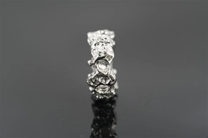 Macro view of vintage silver steel ring featuring unique irregular lava texture and reflections