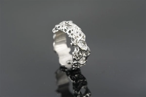 Detailed close-up of vintage irregular textured titanium steel ring with organic lava finish