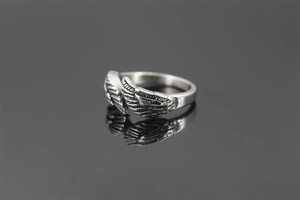 Detailed view of silver angel wing ring with vintage oxidized finish and intricate feathers