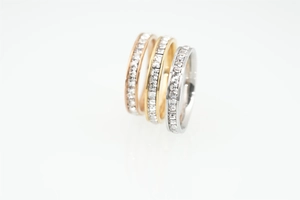 Detailed view of three stackable titanium steel rings with square-cut cubic zirconia inlay