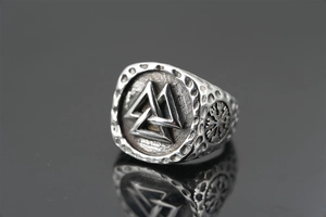 Detailed macro view of Nordic Viking ring featuring Valknut and Vegvisir symbols