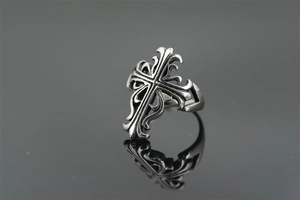 Macro shot of gothic cross ring showing vintage black finish and intricate engravings