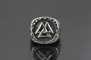 Macro detail of Nordic Viking Valknut ring in silver steel with ornate engraved edges