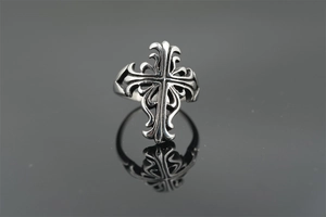 Macro shot of gothic cross ring with intricate vine patterns and vintage hollow carving