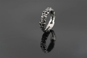 Macro detail of gothic skull ring with vintage oxidized finish on stainless steel band