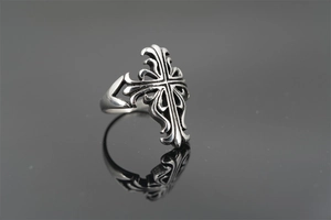 Detailed macro view of vintage gothic cross ring with intricate carved scrollwork