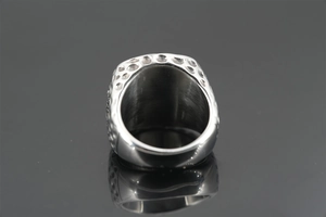 Macro view of textured silver steel ring featuring hammer patterns and polished inner surface