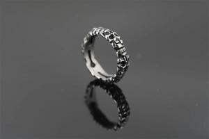 Macro detail of vintage skull ring in titanium steel with detailed punk carvings