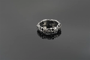 Close-up of vintage gothic skull relief pattern on silver-tone titanium steel ring