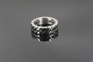 Macro shot of industrial tire tread texture on a vintage titanium steel motor ring for men