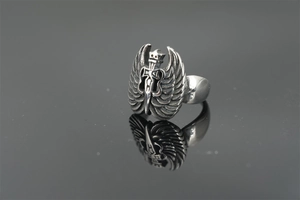 Macro detail of gothic angel wings and crown sword ring with vintage silver finish