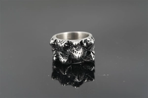 Macro shot of vintage titanium steel ring with textured black oxidized finish and reflection