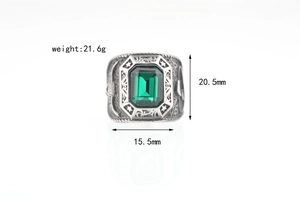Detailed view of punk eagle ring with green gemstone and vintage star patterns