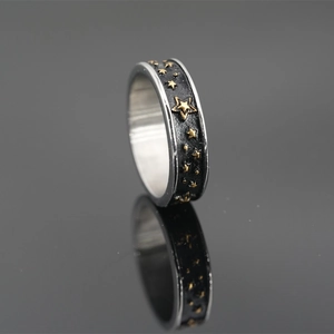 Anello retrò in acciaio al titanio con stelle dorate a rilievo e finitura nera opaca