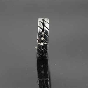 Vintage tire tread pattern stainless steel ring with industrial silver finish and reflection