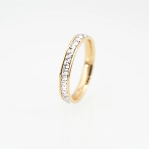 Minimalist gold titanium steel ring featuring sparkling channel-set crystals on white background