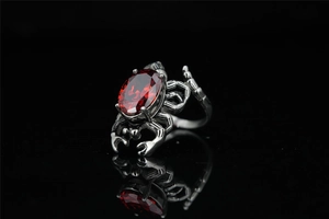 Gothic silver-toned crab ring with faceted red gemstone and detailed dark metal claws