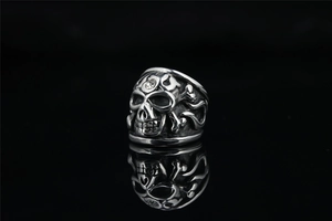 Gothic punk skull ring with silver finish, crystal detail, and mirror reflection