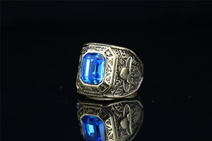 Macro shot of vintage titanium steel eagle ring with blue gemstone and relief details