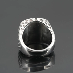 Nordic Viking titanium steel ring with silver dimple texture on a reflective surface