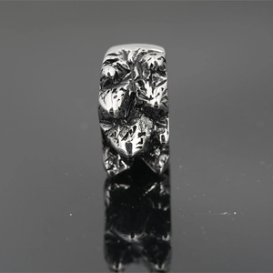 Retro stainless steel ring with rugged lava texture and polished mirror reflection