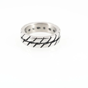 Vintage tire tread pattern ring in silver titanium steel with industrial minimalist design