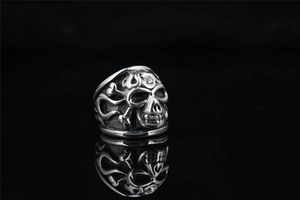 Detail of gothic punk skull ring with oxidized finish and crystal stone forehead inlay
